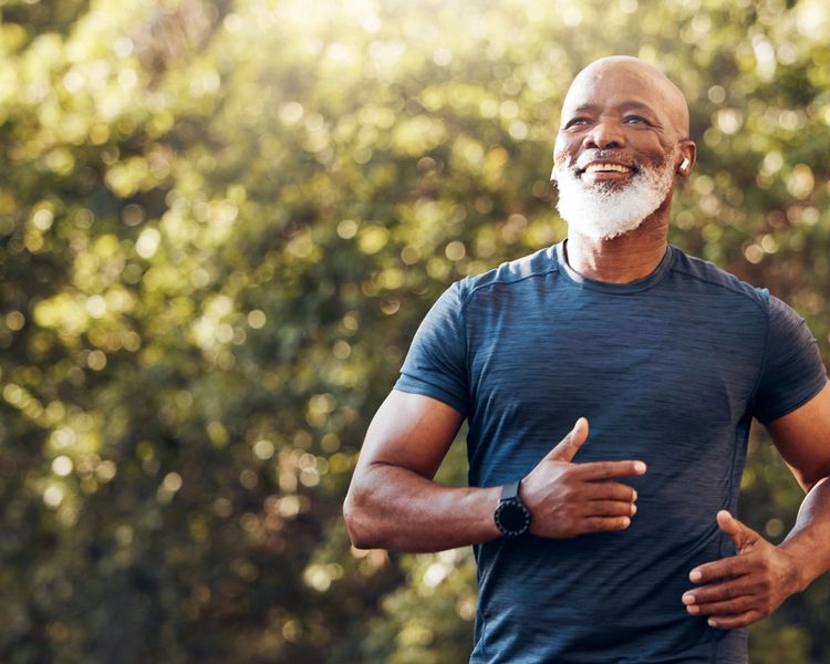 a man with a beard is running in a park .