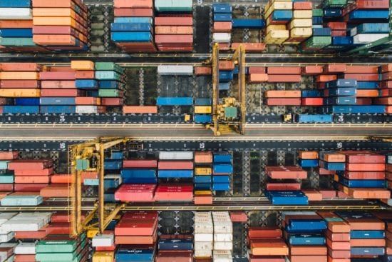 an aerial view of a warehouse filled with lots of shipping containers .