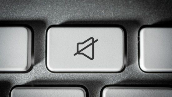 a close up of a computer keyboard with a mute button .
