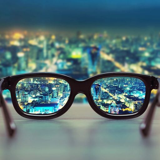 a pair of glasses with a city skyline reflected in the lenses .