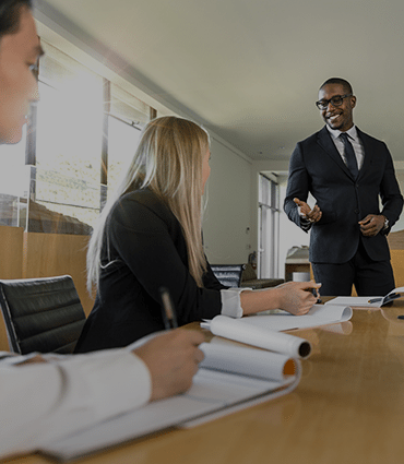 How to inspire people to work with you image of man standing addressing office workers