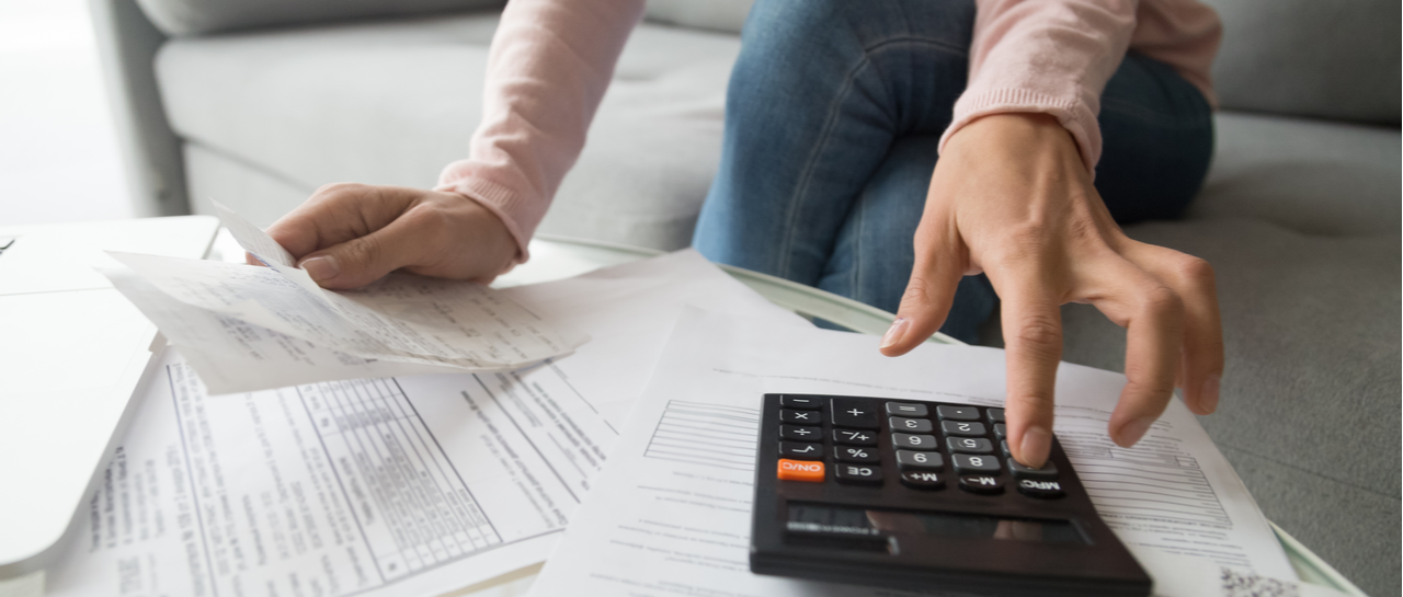 How your business can benefit from the U.S. government’s stimulus package image a woman is using a calculator to calculate her bills