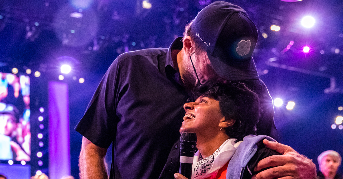 Embracing the gift of grace image of Tony Robbins hugging woman at event