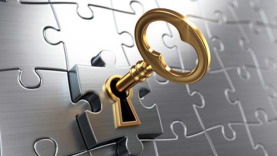 a gold key is sticking out of a keyhole in a puzzle .