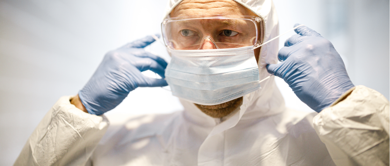 COVID-19 Facts from the Frontline image of a man wearing a mask and gloves