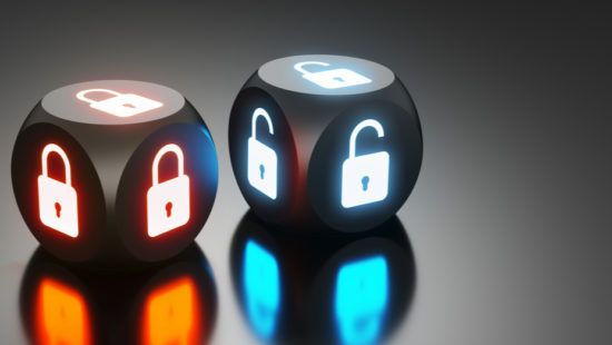 three dice with a padlock on them are sitting on a table .