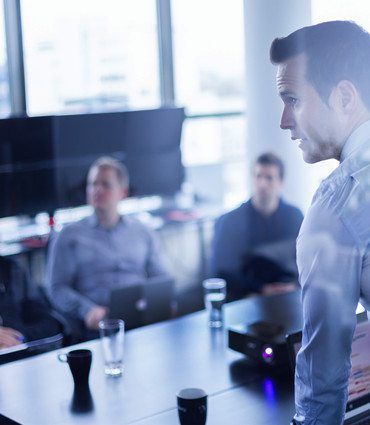 The new psychology of success image of man standing giving a business presentation