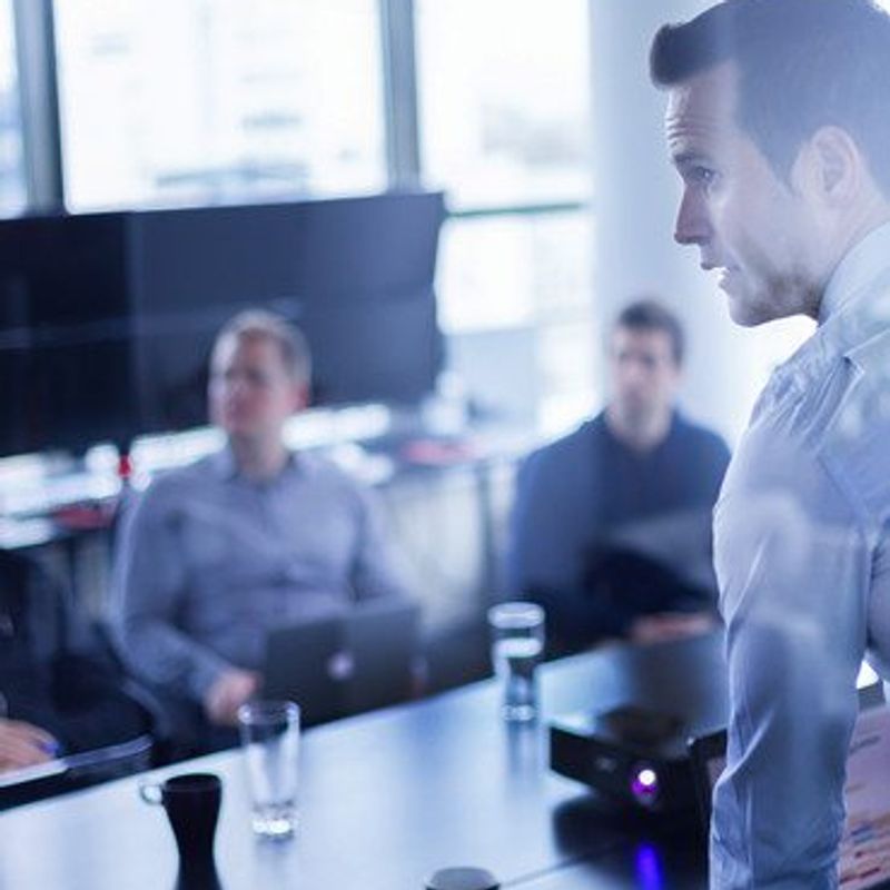 The new psychology of success image of man standing giving a business presentation