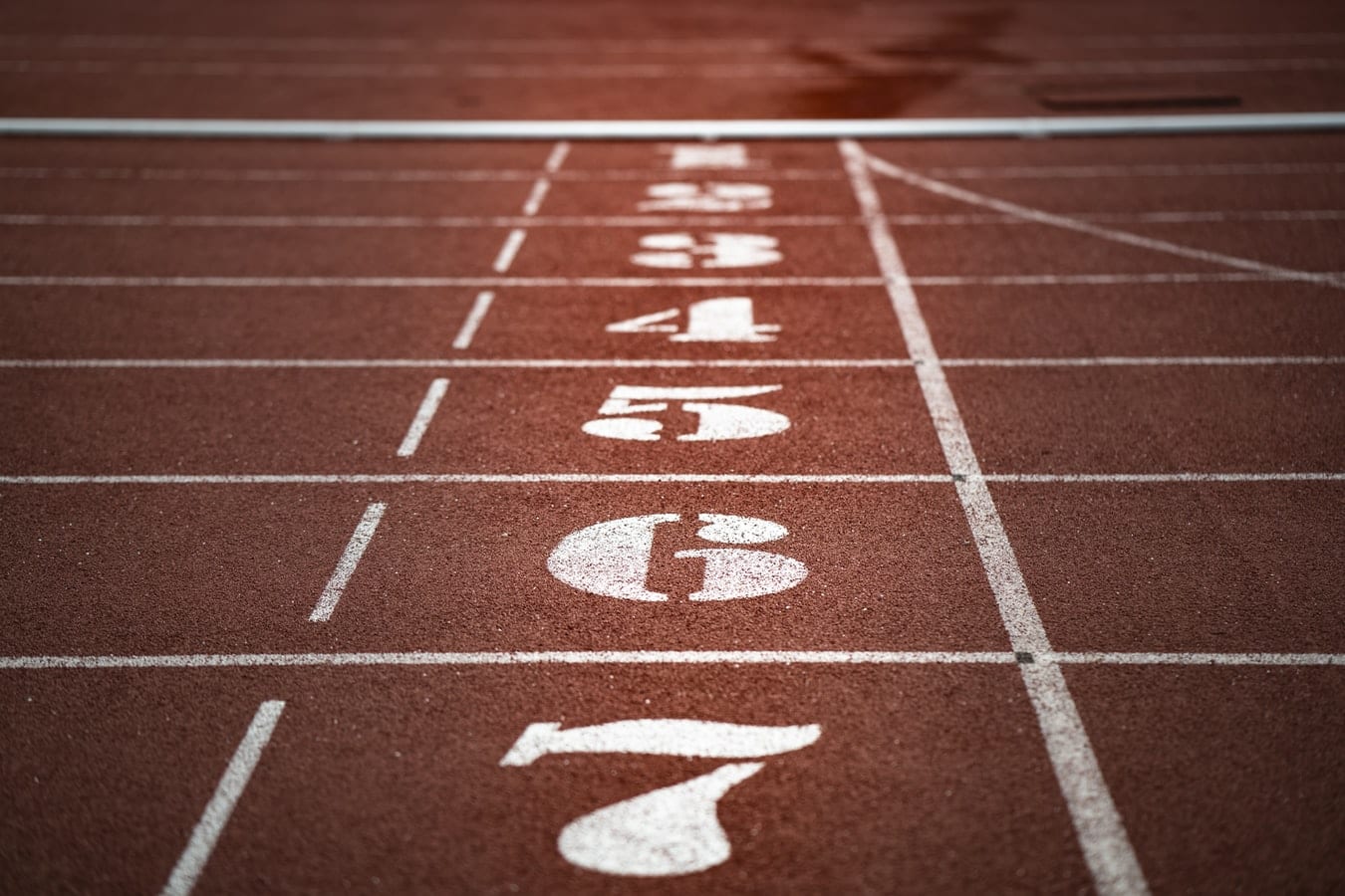 a close up of a running track with numbers painted on it .