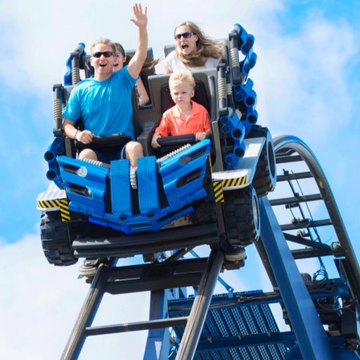 a family is riding a roller coaster at an amusement park .