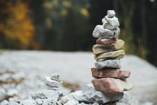 a pile of rocks stacked on top of each other on a rocky hillside .