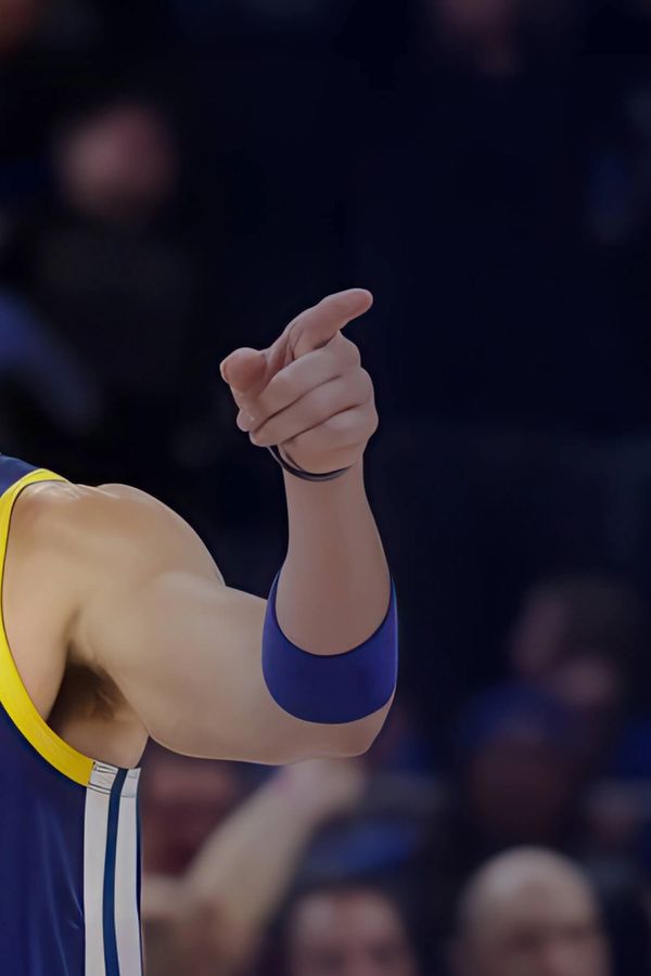 Klay Thompson basketball player for the golden state warriors is pointing at the crowd during a basketball game .