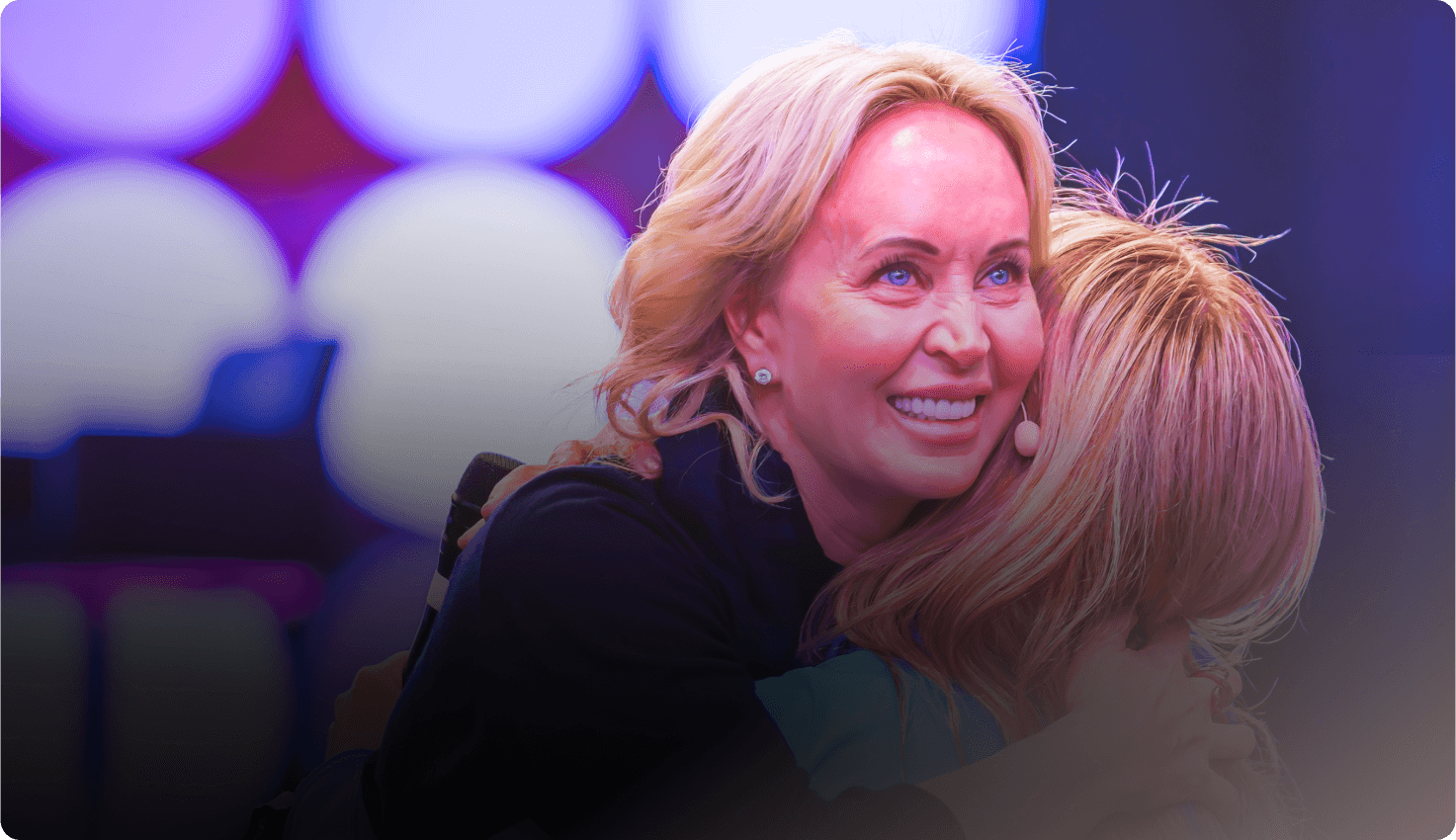 Sage Robbins two women are hugging each other and one is smiling