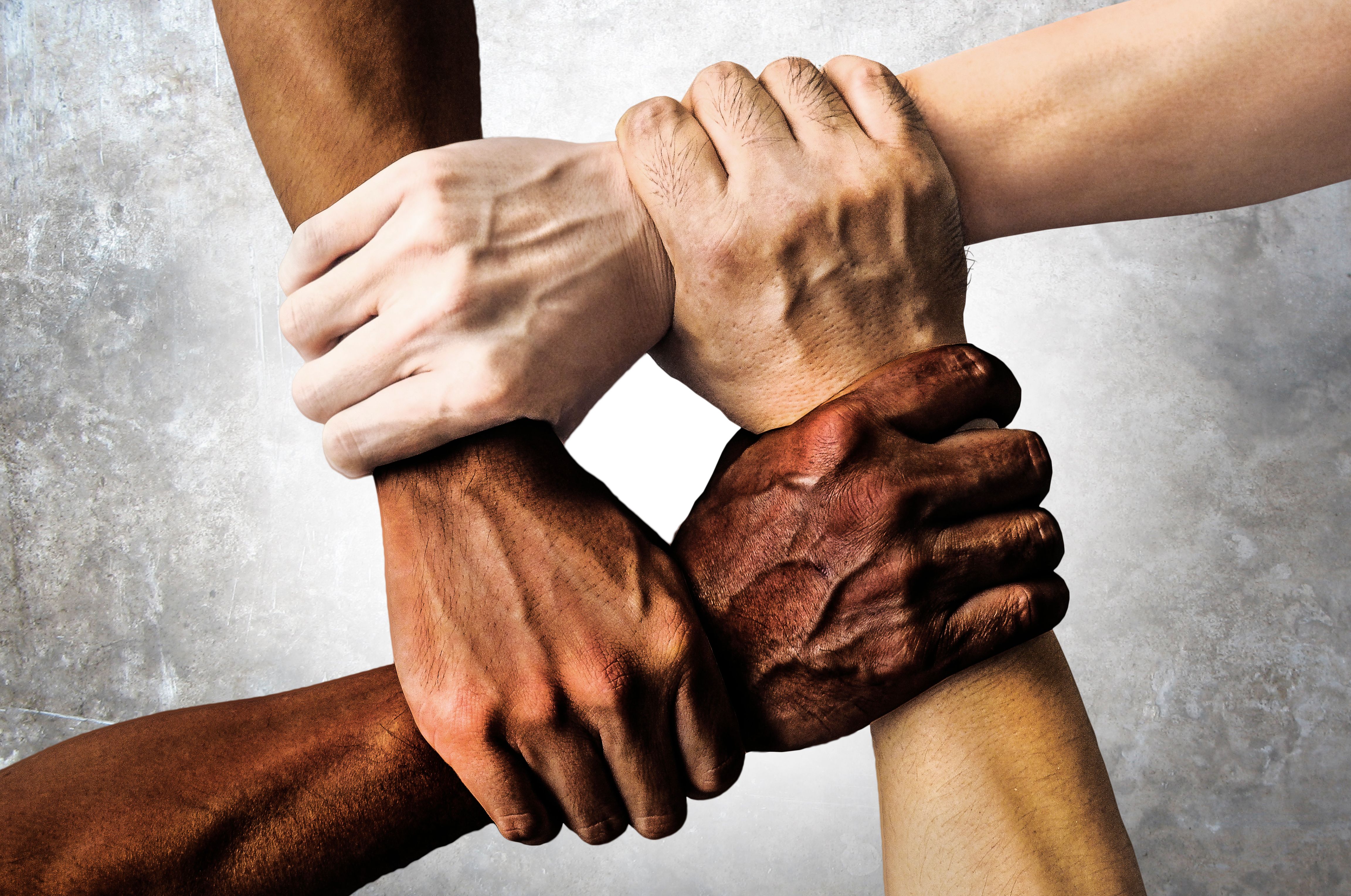 Continuing the Conversation for Healing and Unity image of a diverse group of people are putting their hands together