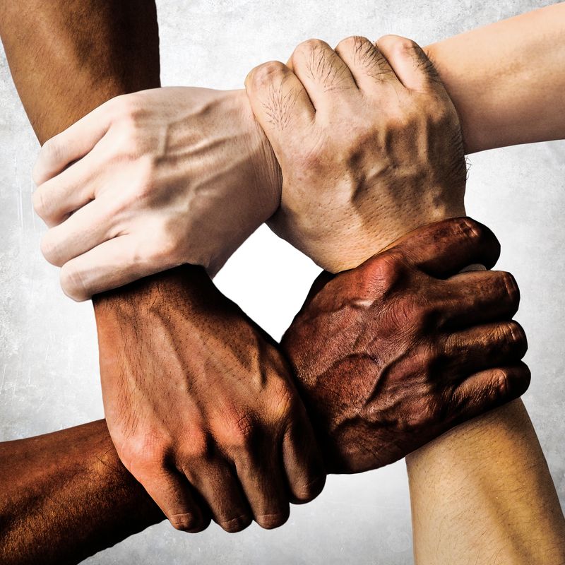 Continuing the Conversation for Healing and Unity image of a diverse group of people are putting their hands together