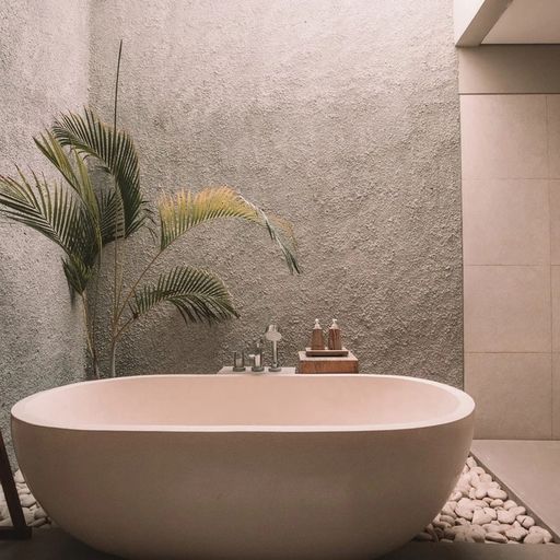 a bathroom with a bathtub and a palm tree .