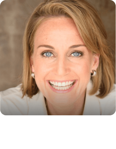 Bari Baumgardner with blonde hair and blue eyes smiles for the camera