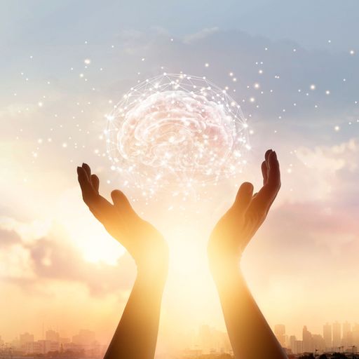 a person is holding a glowing ball in their hands .