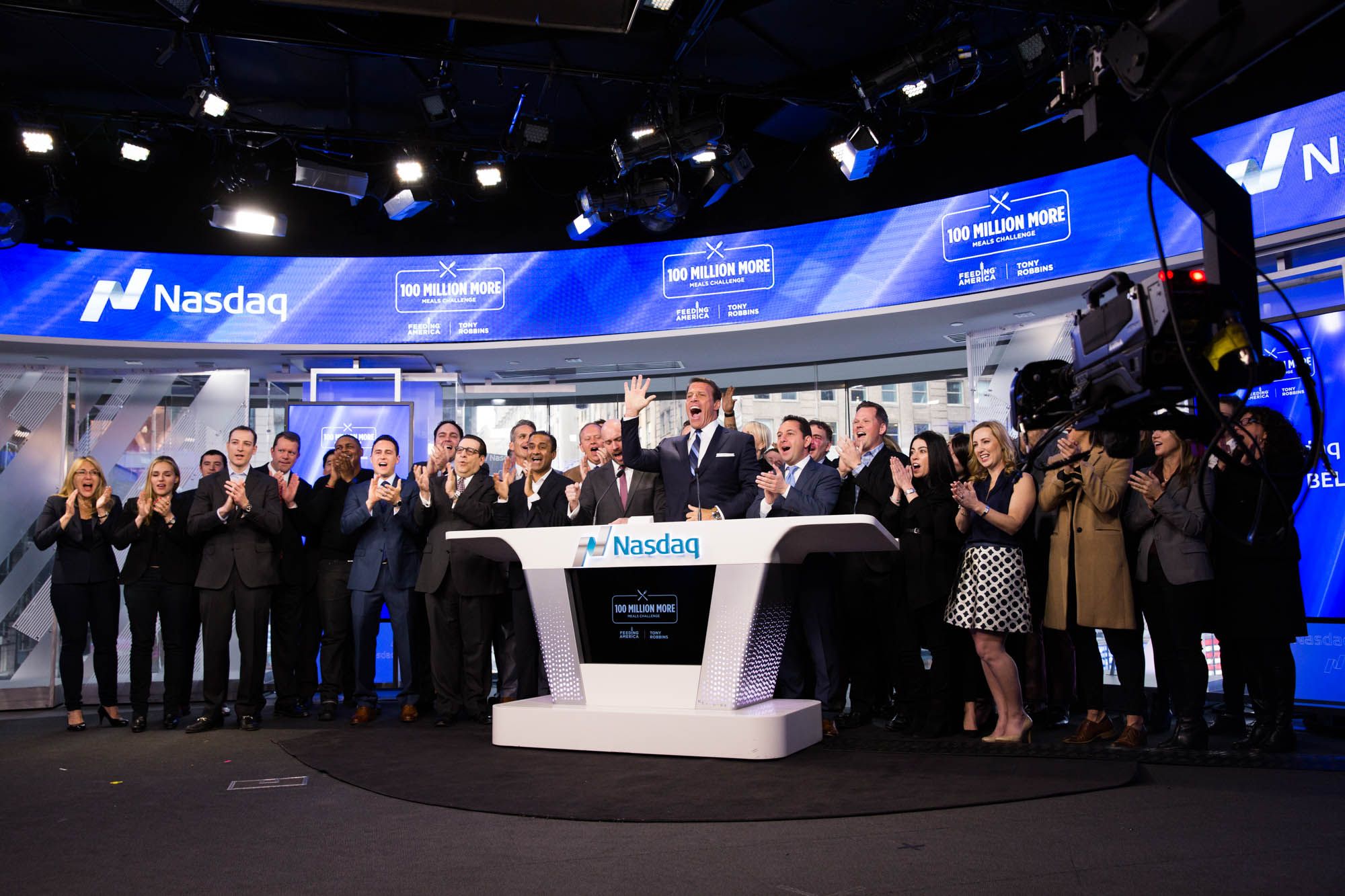 a group of people are standing around a table in a room .