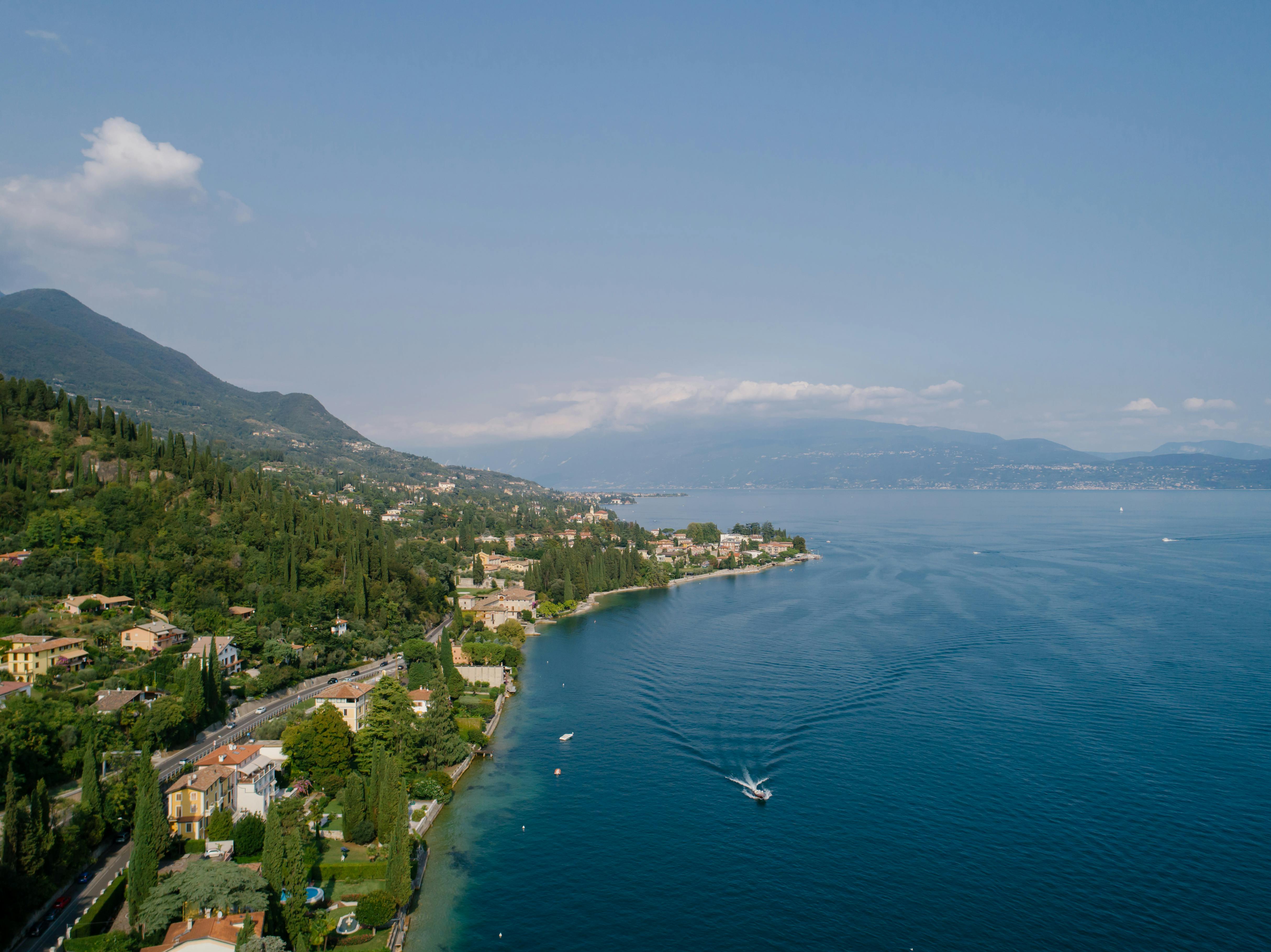 an aerial view of a lake with a boat in the water .