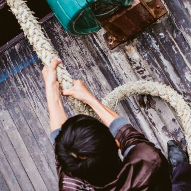 What’s your secret identity? Image of man pulling on thick rope