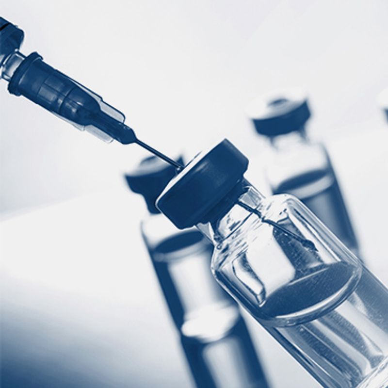 Affordable, scalable, and accessible image of a syringe is being inserted into a bottle of vaccine .