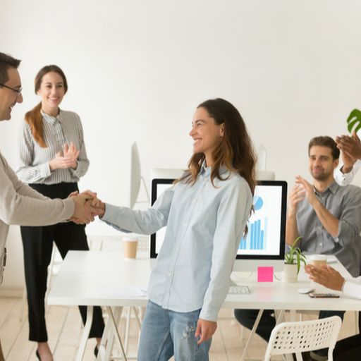 a group of people are shaking hands in an office .