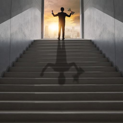 a man is standing on a set of stairs with his shadow on the stairs .