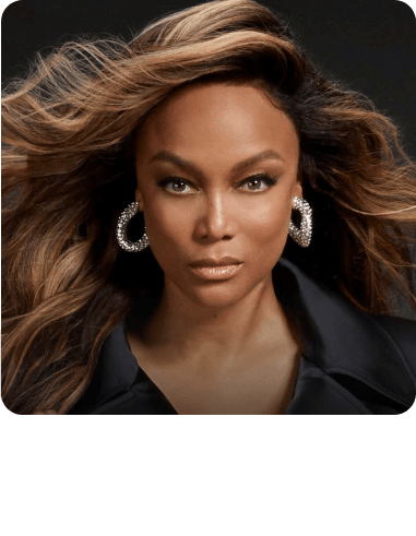 a close up of Tyra Banks wearing hoop earrings