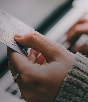 Building a brand on customer service image of hand holding credit card