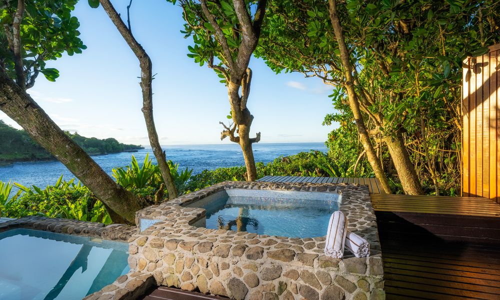 there is a hot tub with a view of the ocean .