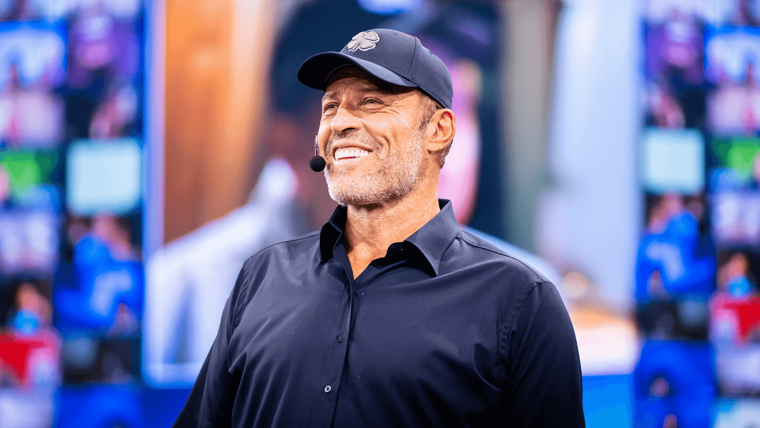 Tony Robbins wearing a hat with a clover on it