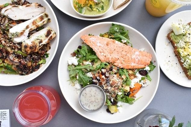 a table topped with plates of food and drinks .