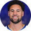 Klay Thompson a basketball player with a beard is smiling for the camera .
