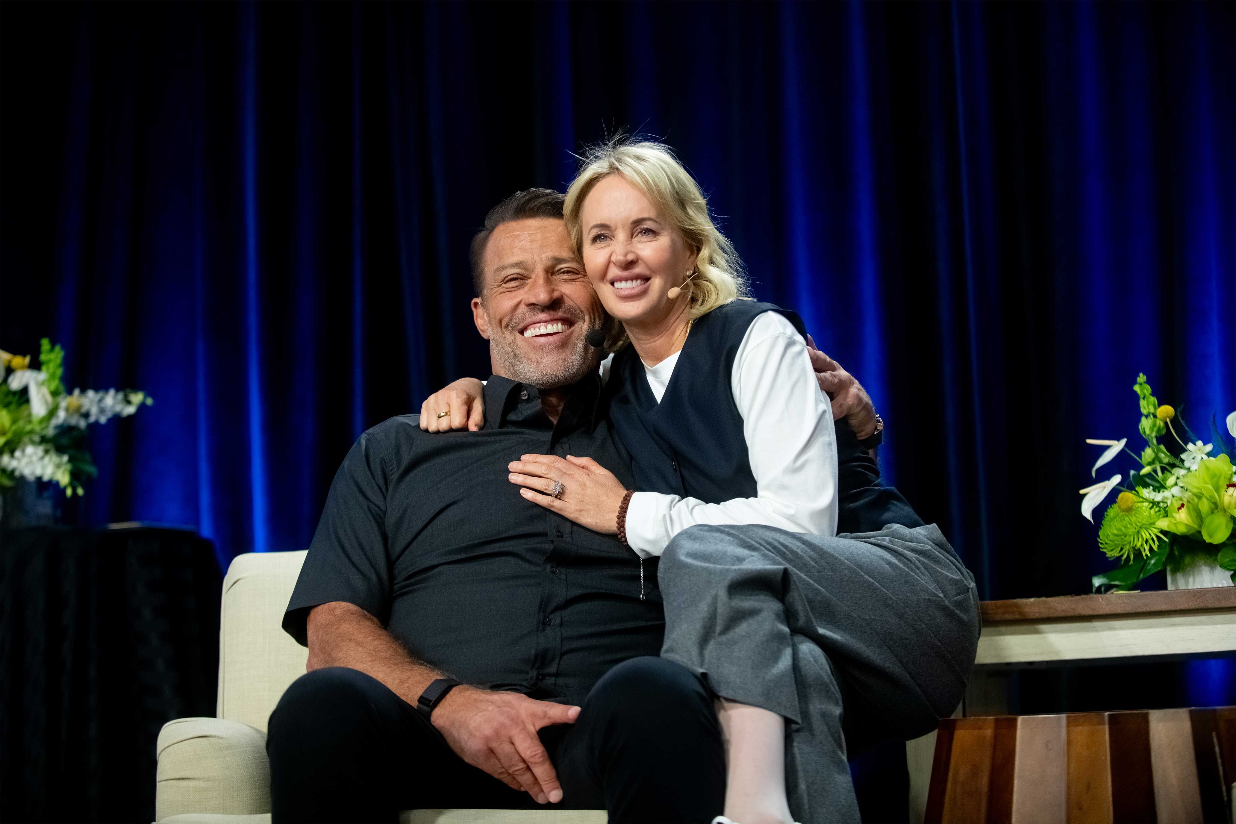 a man and a woman are sitting next to each other on a couch .