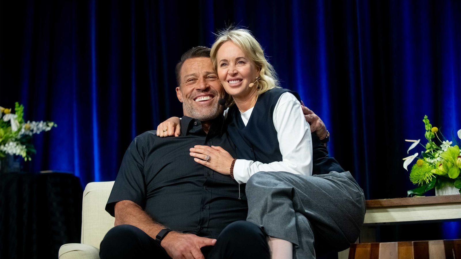 a man and a woman are sitting next to each other on a couch .