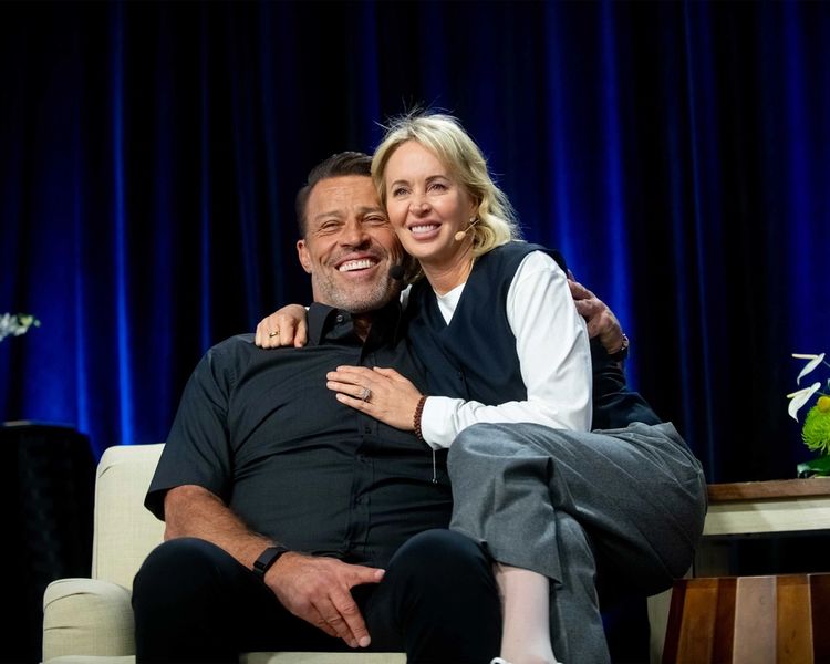a man and a woman are sitting next to each other on a couch .