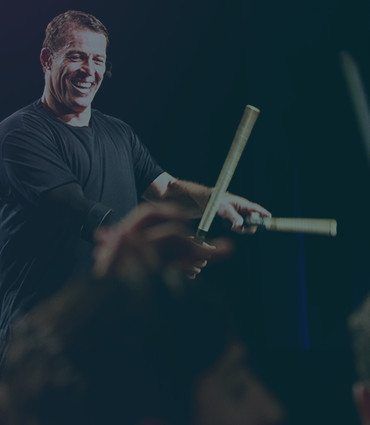 How to breakthrough to success image of Tony Robbins on stage