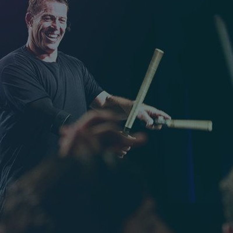 How to breakthrough to success image of Tony Robbins on stage