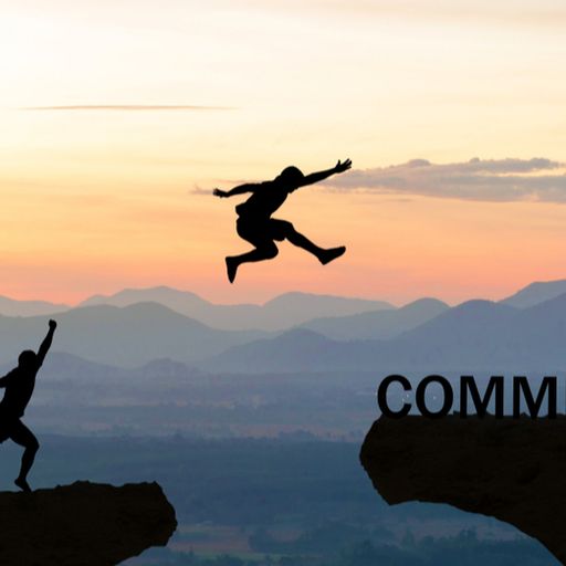 a man is jumping over a cliff with the word commitment in the background .
