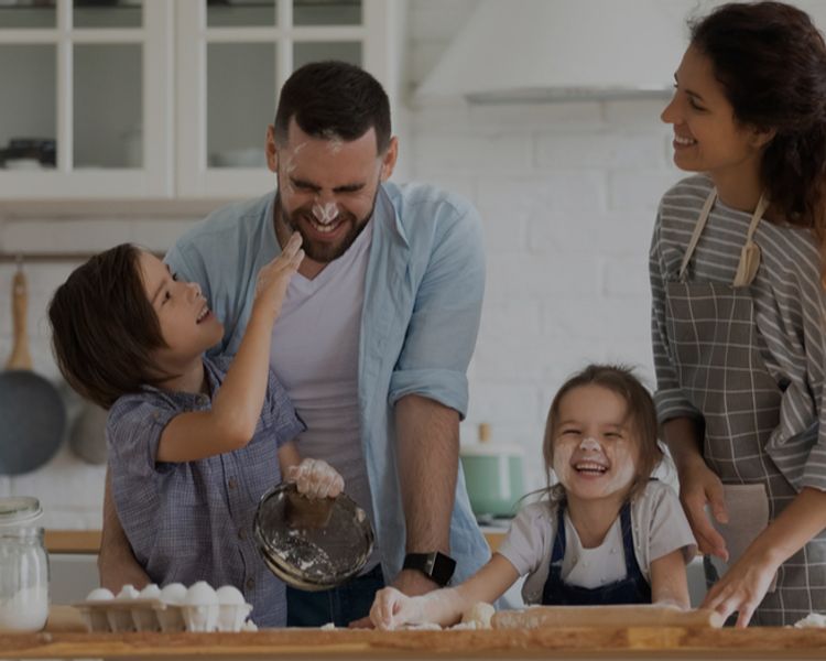 a family is preparing food together in the kitchen .