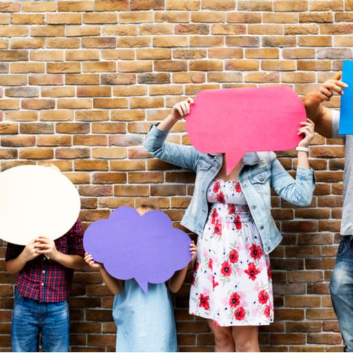 a group of people are holding speech bubbles in front of their faces .