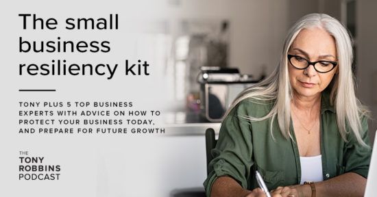 woman is sitting at a desk using a laptop computer