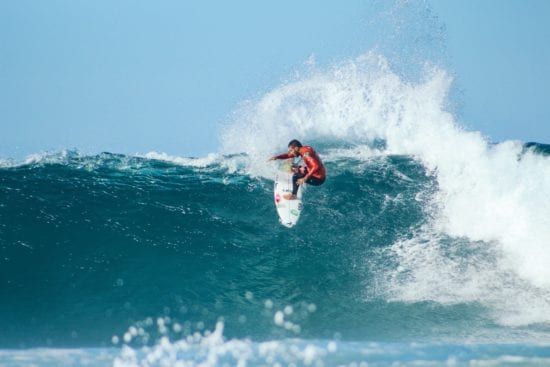 a man is riding a wave on a surfboard in the ocean .
