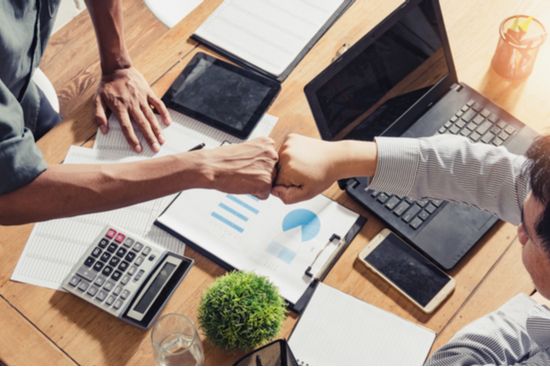 two people fist bump during a meeting