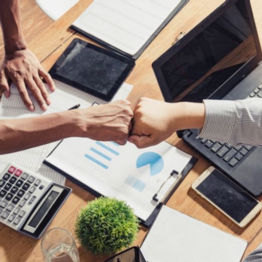 two people fist bump during a meeting