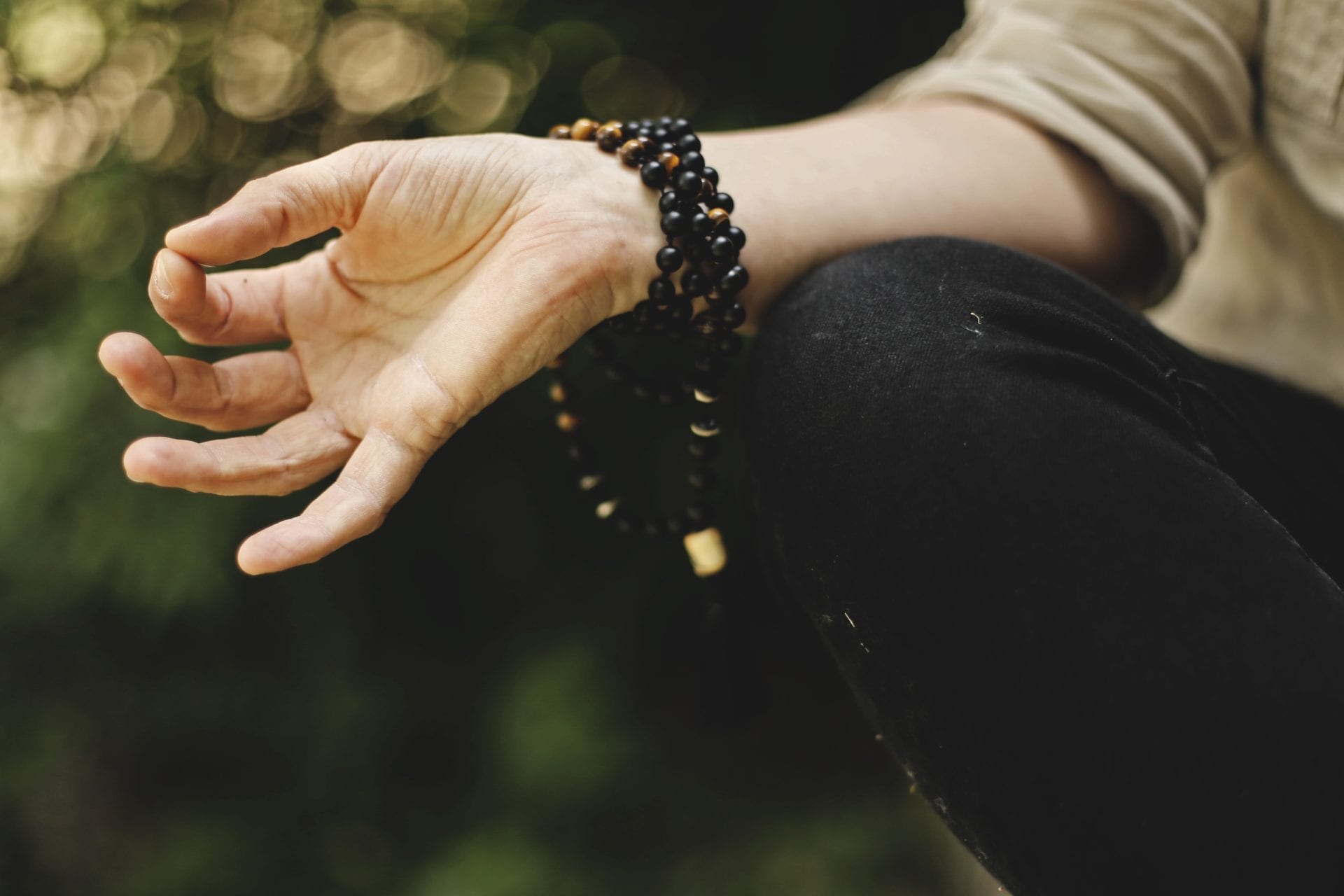 a close up of a person 's hand with a bracelet on it .
