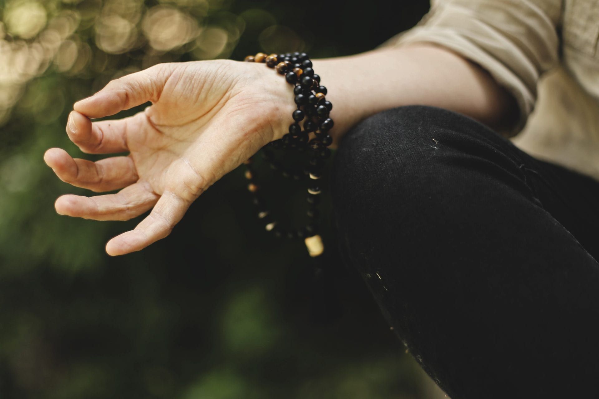 a close up of a person 's hand with a bracelet on it .