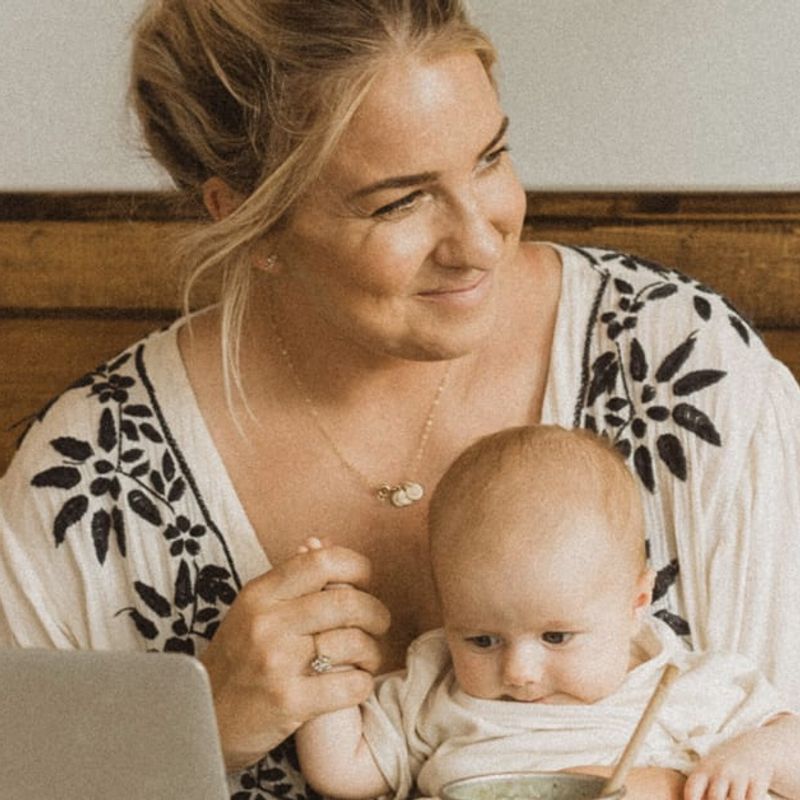 How to be more productive image of Jenna Kutcher with baby behind laptop