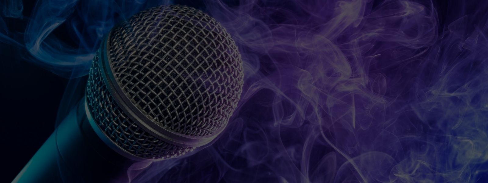 The Mic is Mightier than the Sword closeup image of a microphone with smoke background
